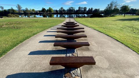 artistic benches in front of a river