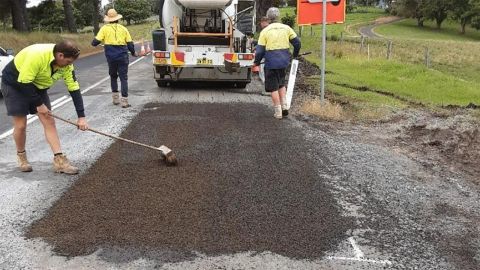 Eurobodalla Council crew patching potholes on a road.