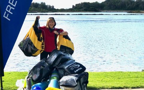 Donna McLean in front of the Narooma estuary with sports equipment