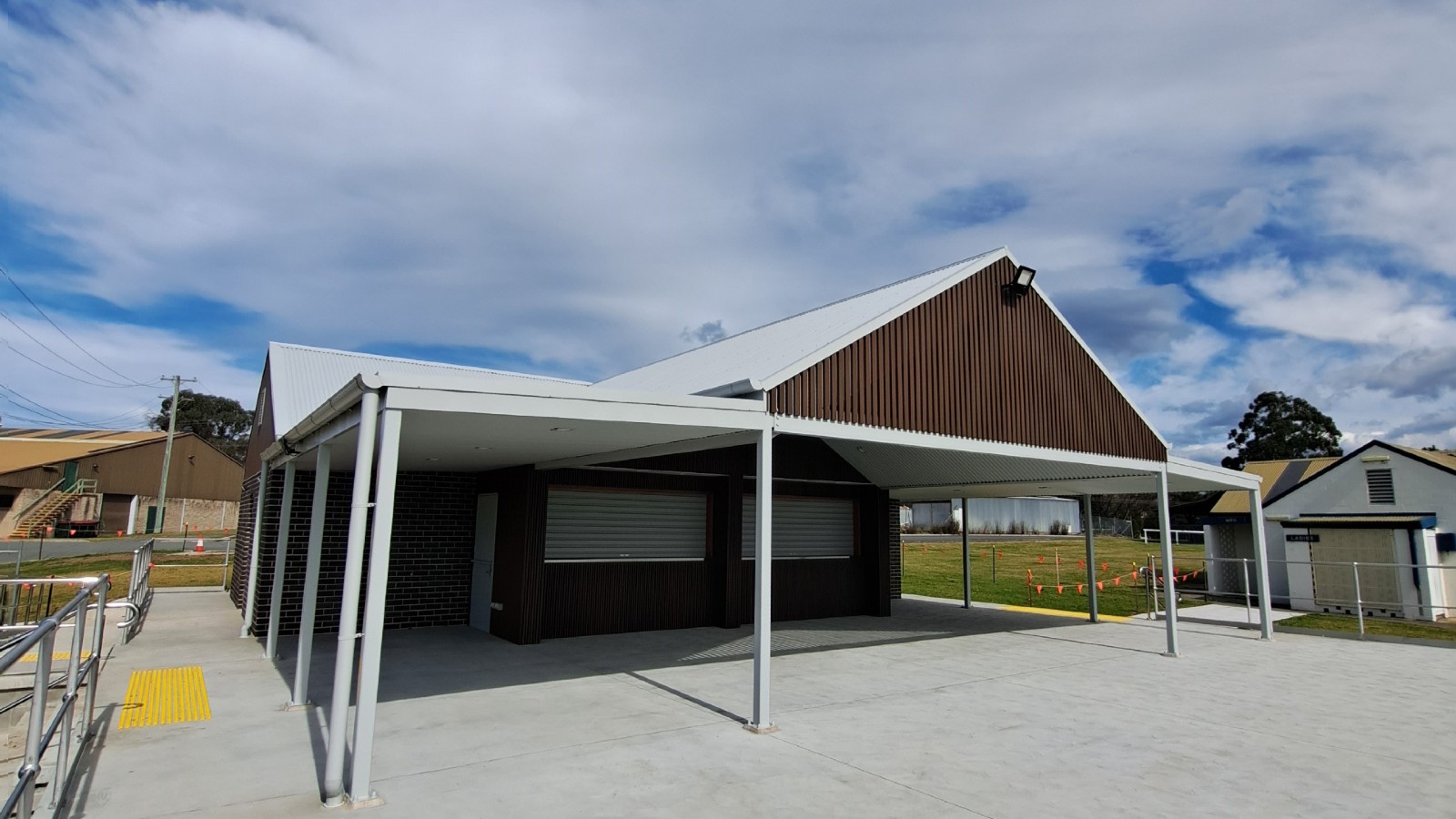 Image A brick building with covered concrete deck and large canteen shutters