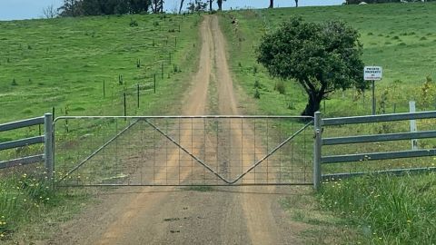Closed gate to a dirt road