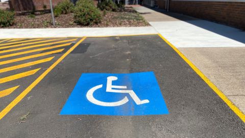An accessible car park out the front of a building.