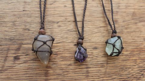 Three wrapped crystal necklaces.
