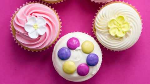 Three colourful iced cupcakes