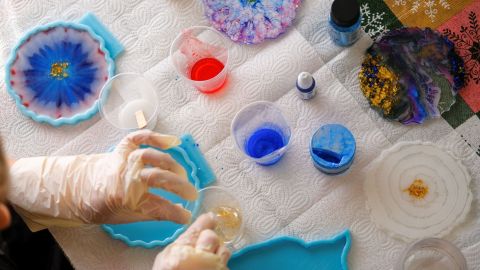 close-up of a person creating resin pieces.