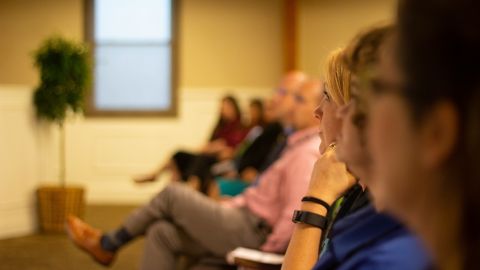 A slightly blurred image of people paying attention.