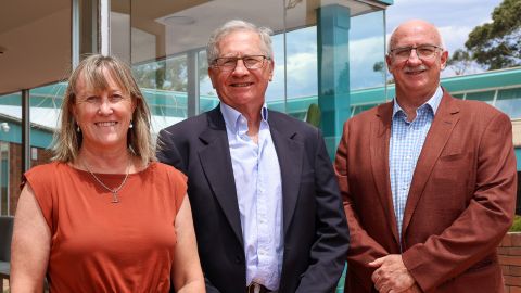 three people standing outside of council's building 