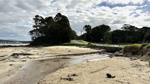 A waterway through a sandy beach