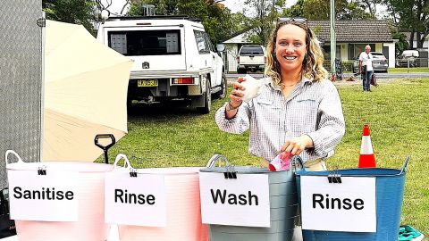 Lady behind four wash tubs