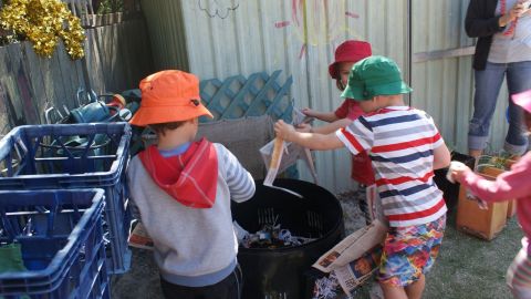 Kids setting up a compost bin