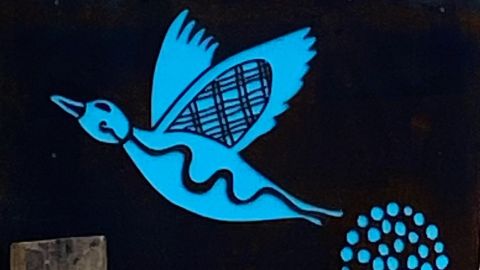 Close up of roadside sign with image of blue duck