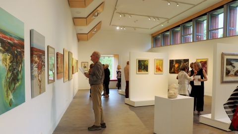 People viewing artworks on the walls of the Basil Sellers Exhibition Centre