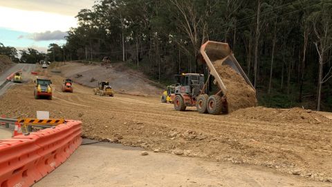 Earthmoving machines work within a worksite.